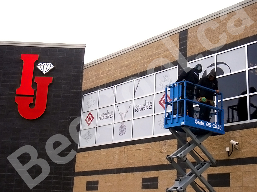 Bee Cool Glass Coatings - Perforated Graphic Film installation techs on lift.