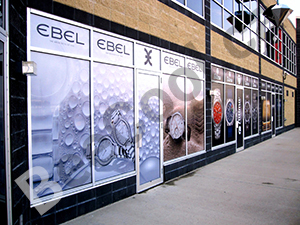 Perforated printable graphic film for window advertisments