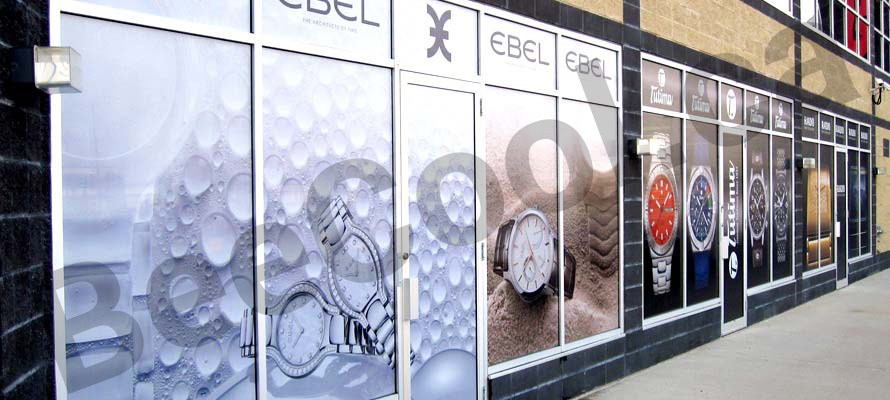 Storefront business windows with Bee Cool printed perforated vinyl installed.