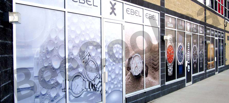 Red Deer storefront windows with extensive graphic perforated film laminate to promote products & services.